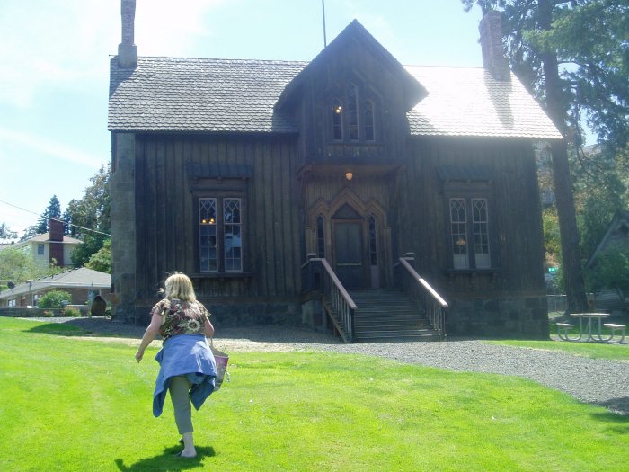 Carol walking among the buildings of the Fort Dalles Museum