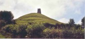 Glastonbury Tor, the legendary Isle of Avalon, where Arthur is said to have died.  It is now believed that the area surrounding this Tor was under water in the 5th century.  The ruins of the church on top were built much later.