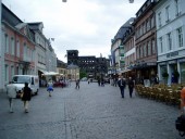 Trier, Germany.  The Porta Nigra, a colossal Roman gate, can be seen at the end of the street.