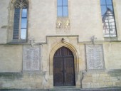 Church in Ofterdingen, Germany.  On either side of the door are memorials listing the townsmen who died in World War I.