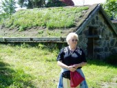 Mom outside a farmhouse in Skansen